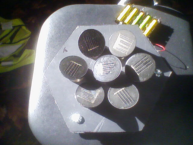 Hexagonal array of solar cells built from garden lights.