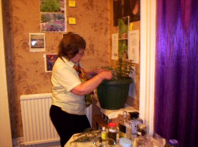 Judith attends to the raffle prize of a bucket of herbs.