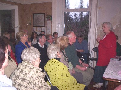 The audience listens intently.