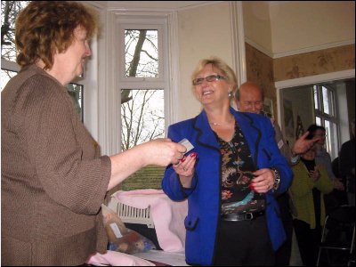 Vivien Carter presents the cheque to Jean the treasurer.
