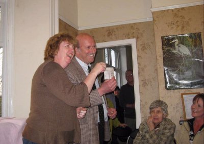 Brian and Jean happily accept the cheque.